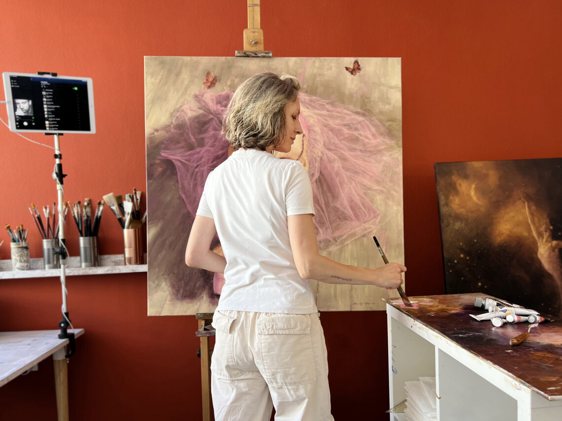 Artist Alexandrina Karadjova in her studio painting