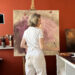 Artist Alexandrina Karadjova in her studio painting
